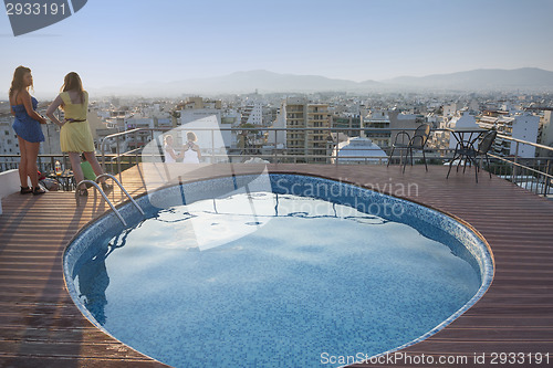 Image of People on terrace watching cityscape of Athens