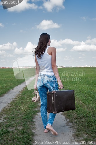 Image of Attractive woman with old suitcase goes afar