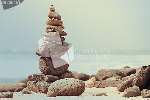 Image of Close-up of white pebbles stack over sea 