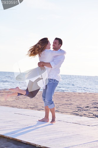 Image of young couple  on beach have fun