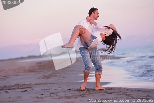 Image of young couple  on beach have fun