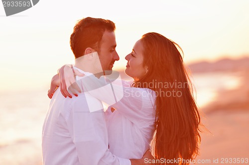 Image of young couple  on beach have fun