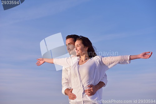 Image of young couple  on beach have fun