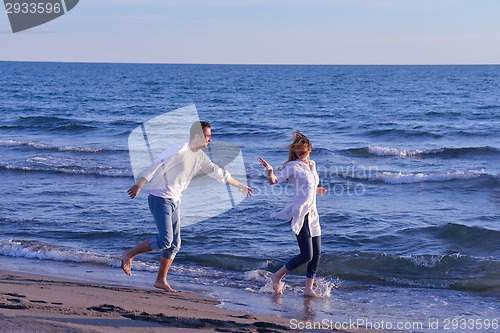 Image of young couple  on beach have fun