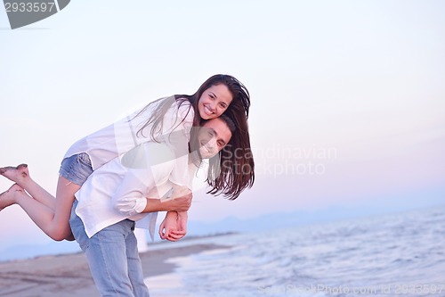 Image of young couple  on beach have fun