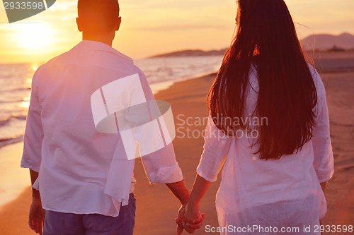 Image of young couple  on beach have fun