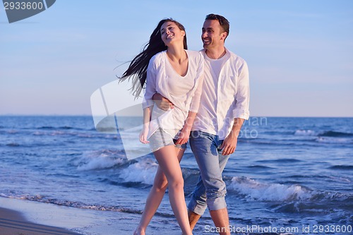 Image of young couple  on beach have fun