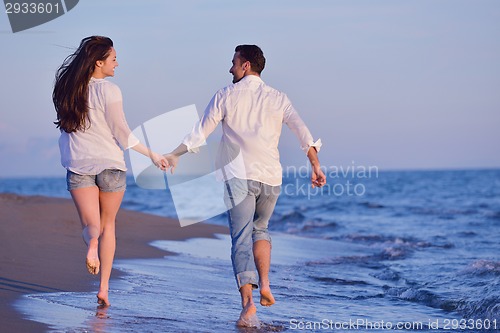 Image of young couple  on beach have fun