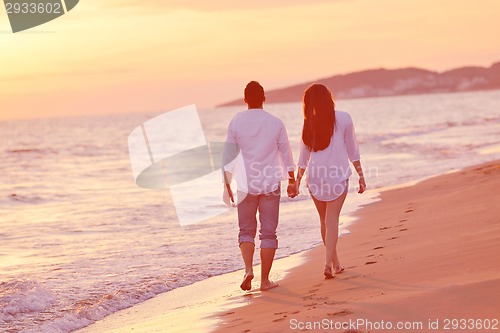Image of young couple  on beach have fun