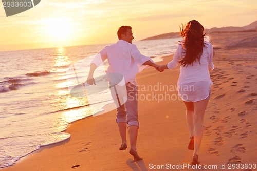 Image of young couple  on beach have fun