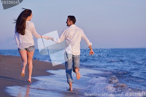 Image of young couple  on beach have fun