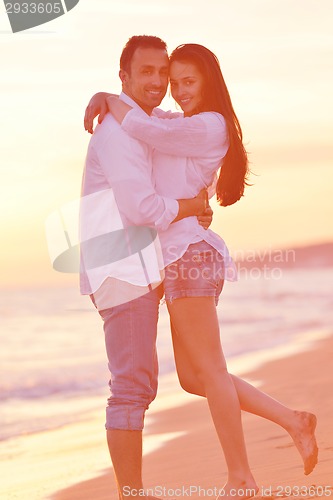 Image of young couple  on beach have fun