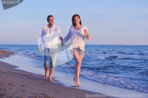 Image of young couple  on beach have fun