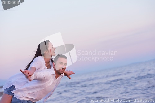 Image of young couple  on beach have fun