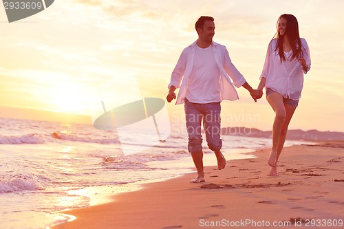 Image of young couple  on beach have fun