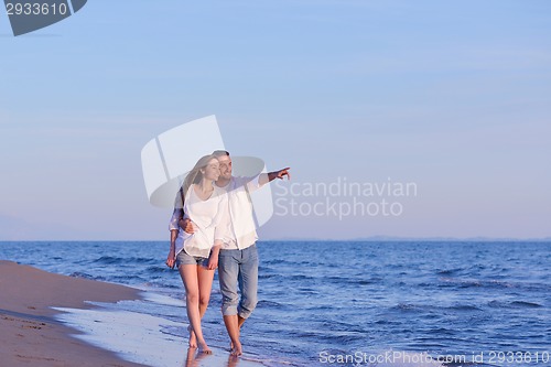 Image of young couple  on beach have fun