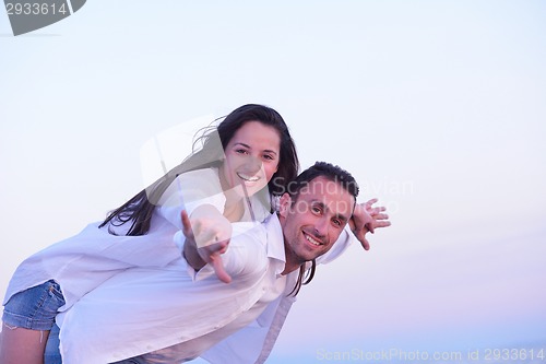 Image of young couple  on beach have fun