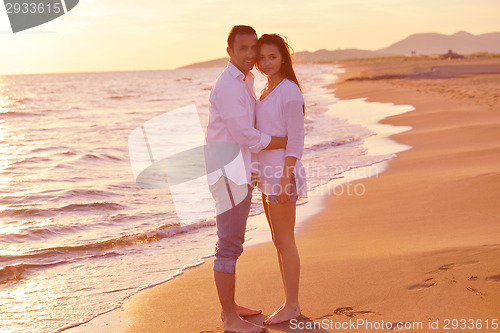 Image of young couple  on beach have fun