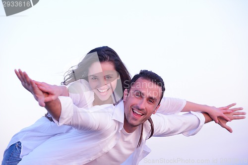 Image of young couple  on beach have fun