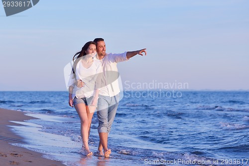 Image of young couple  on beach have fun
