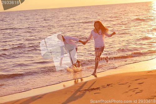 Image of young couple  on beach have fun