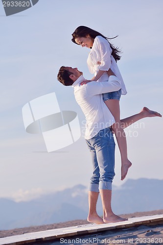 Image of young couple  on beach have fun