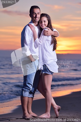 Image of young couple  on beach have fun