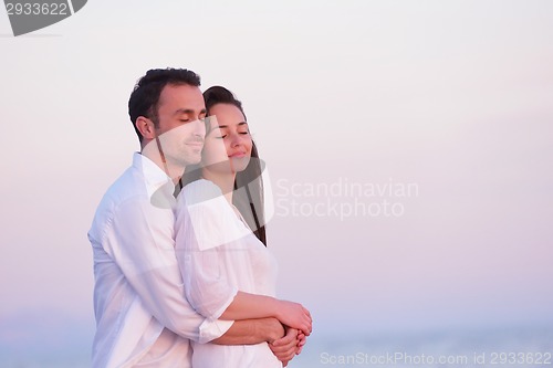 Image of young couple  on beach have fun