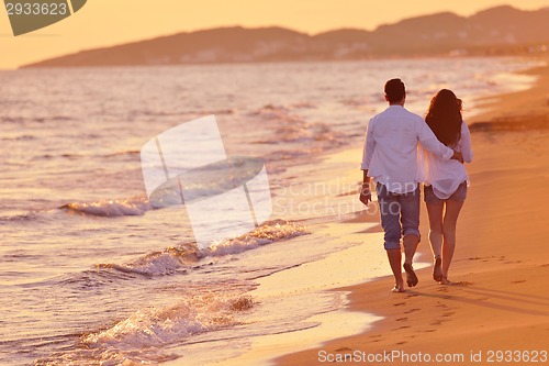 Image of young couple  on beach have fun