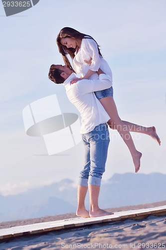 Image of young couple  on beach have fun