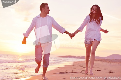 Image of young couple  on beach have fun