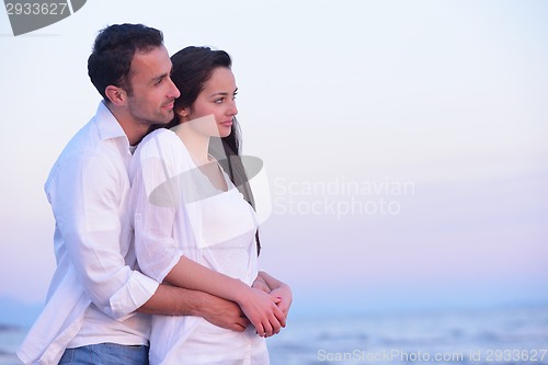 Image of young couple  on beach have fun