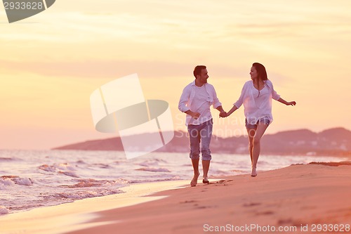 Image of young couple  on beach have fun