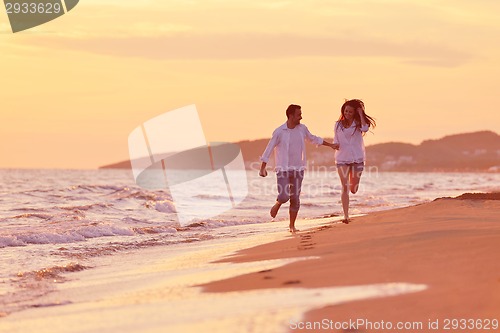 Image of young couple  on beach have fun