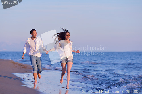 Image of young couple  on beach have fun