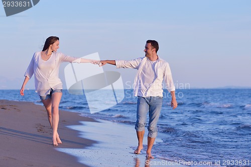 Image of young couple  on beach have fun