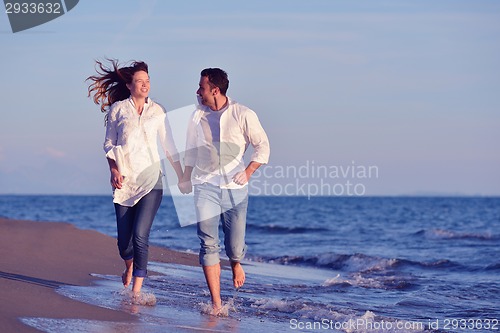 Image of young couple  on beach have fun