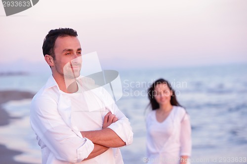 Image of young couple  on beach have fun
