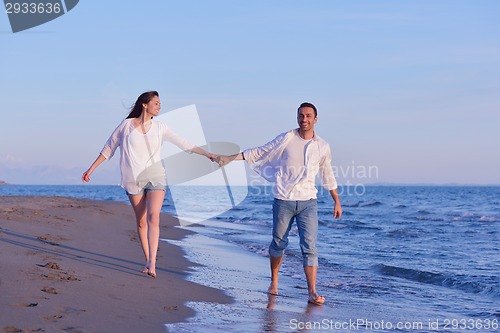 Image of young couple  on beach have fun