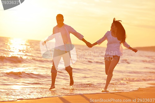 Image of young couple  on beach have fun