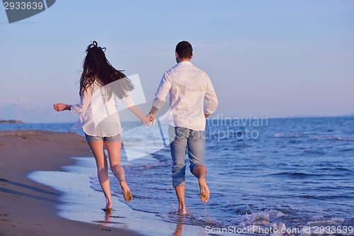 Image of young couple  on beach have fun