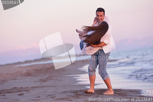 Image of young couple  on beach have fun