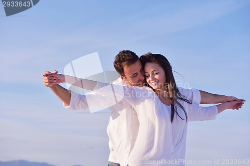 Image of young couple  on beach have fun
