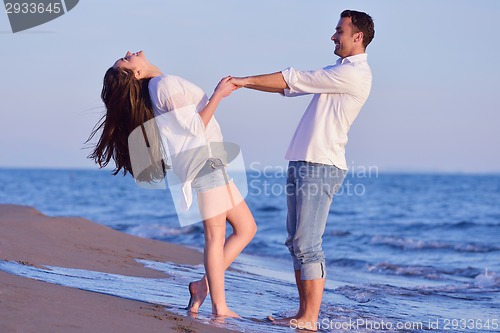 Image of young couple  on beach have fun