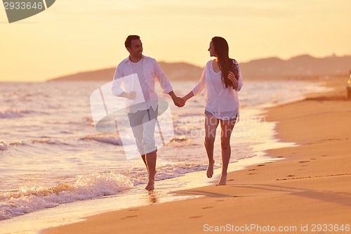 Image of young couple  on beach have fun