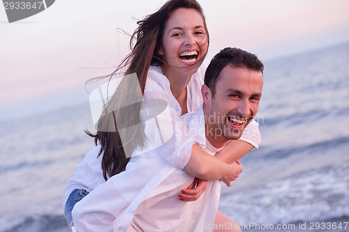 Image of young couple  on beach have fun