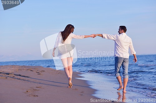 Image of young couple  on beach have fun