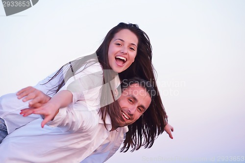 Image of young couple  on beach have fun
