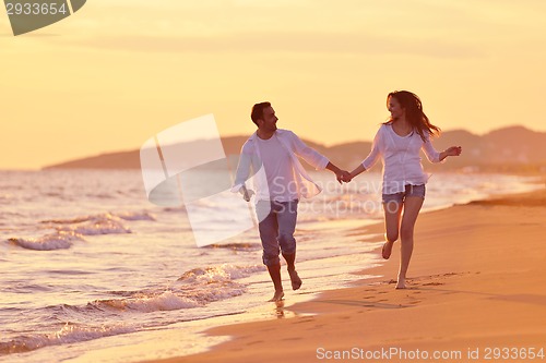 Image of young couple  on beach have fun