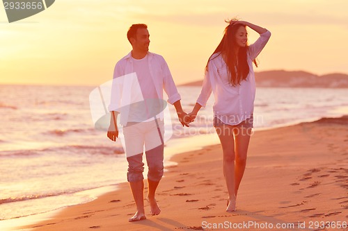 Image of young couple  on beach have fun